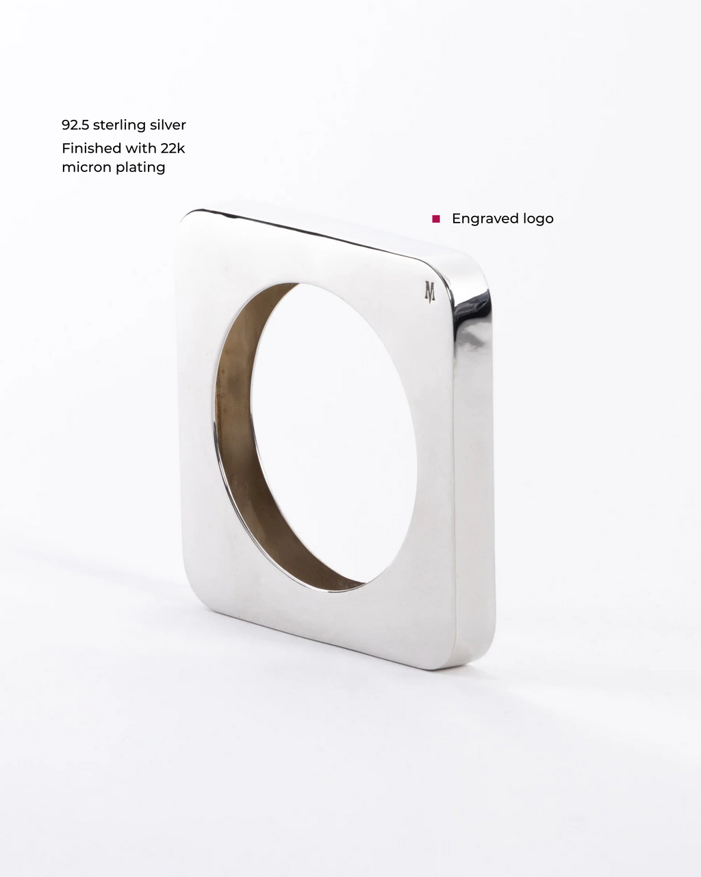 Close-up of a sleek Edge Mega Bangle jewelry piece by MAISON MEGH, showcasing its modern, polished design.