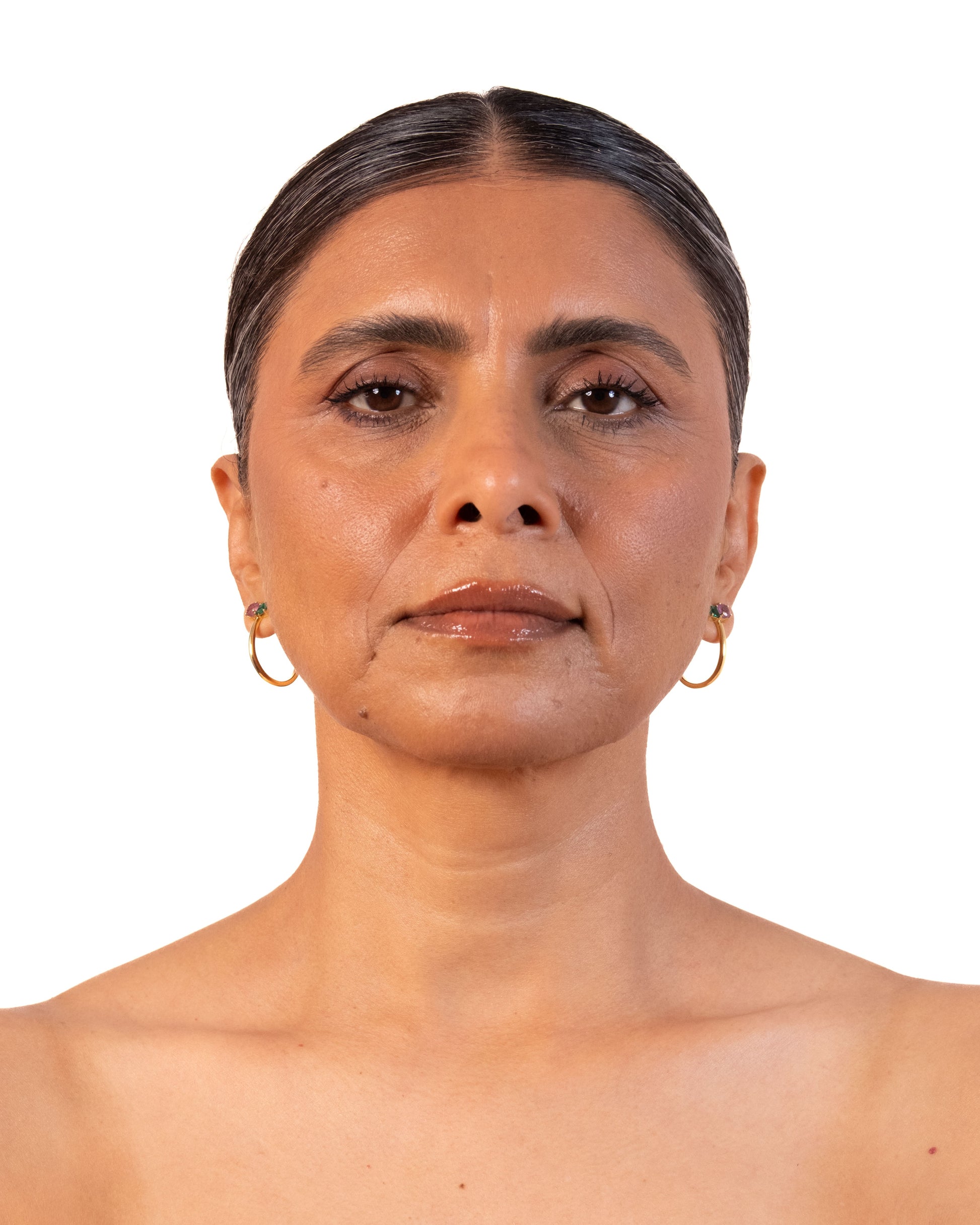 Gold duo hoop earrings by MAISON MEGH, featuring sleek, layered design with shiny finish, displayed on a white background.