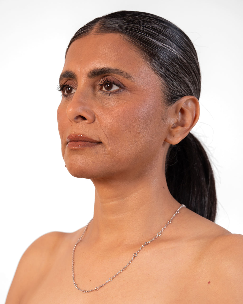 Silver Tiny Linky Chain with small circular links from MAISON MEGH, close-up of delicate jewelry chain.
